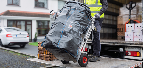 ECOFUEL™ CityBag® kiln-dried firewood being moved on a hand trolley during home delivery.