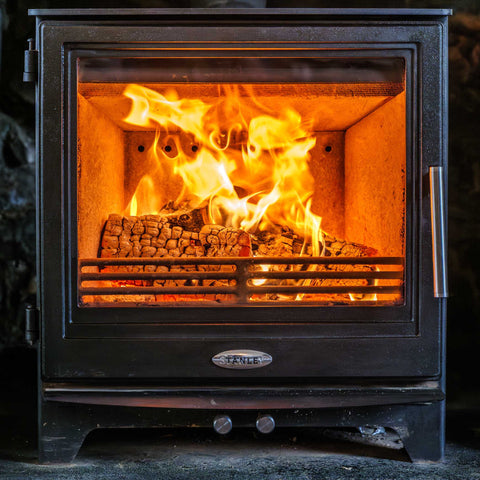 Wood burning stove with flames inside, brand 'stanley visible