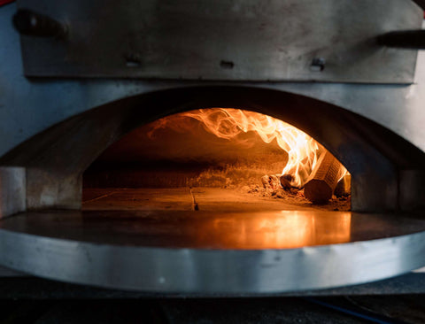 forno1889 pizza logs burning inside the pizza oven