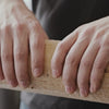 Breaking ECOFUEL™ EcoBriquettes in half — dense compressed hardwood fuel, easy to size for your firebox or stove.